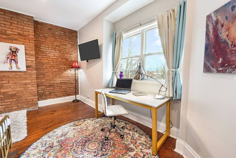 An expansive workspace with a view of downtown. (Third Floor South Bedroom)