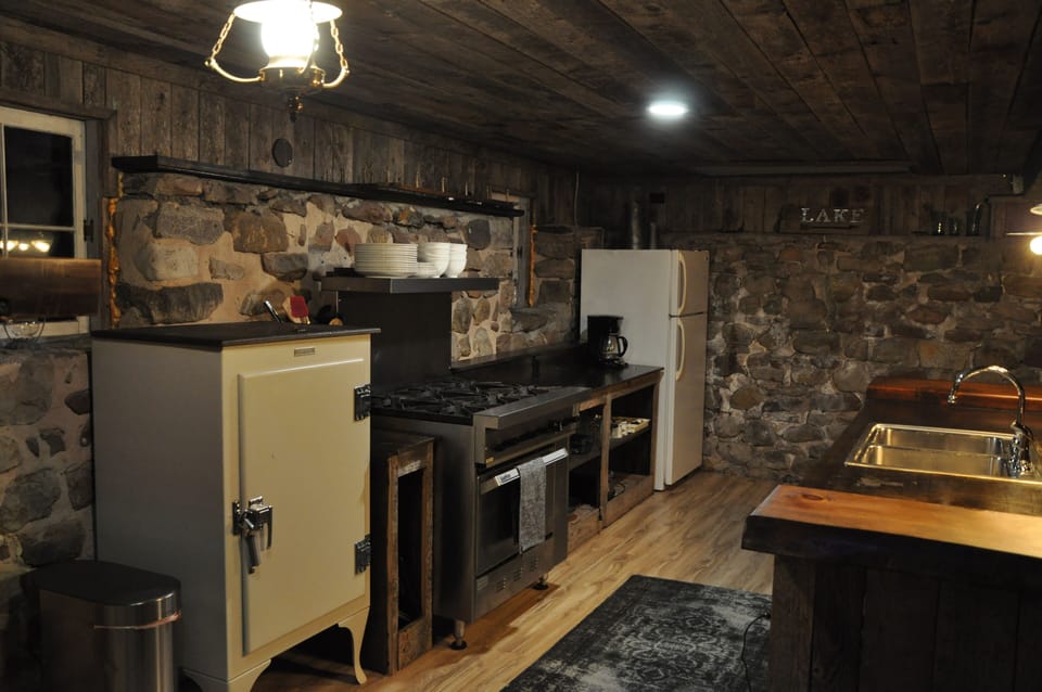 Old refrigerator turned into pantry. Commercial gas stove. 