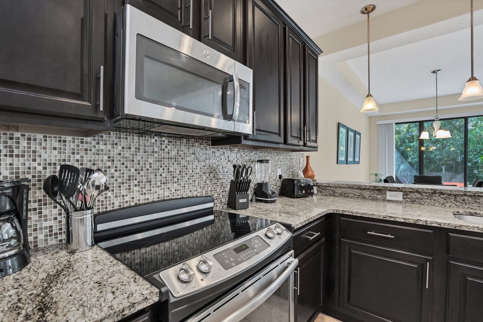 Stainless steel appliances and granite counters ready for home-cooked meals.