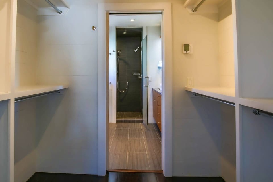 A walk-in closet separates the primary bedroom from the en suite bathroom.