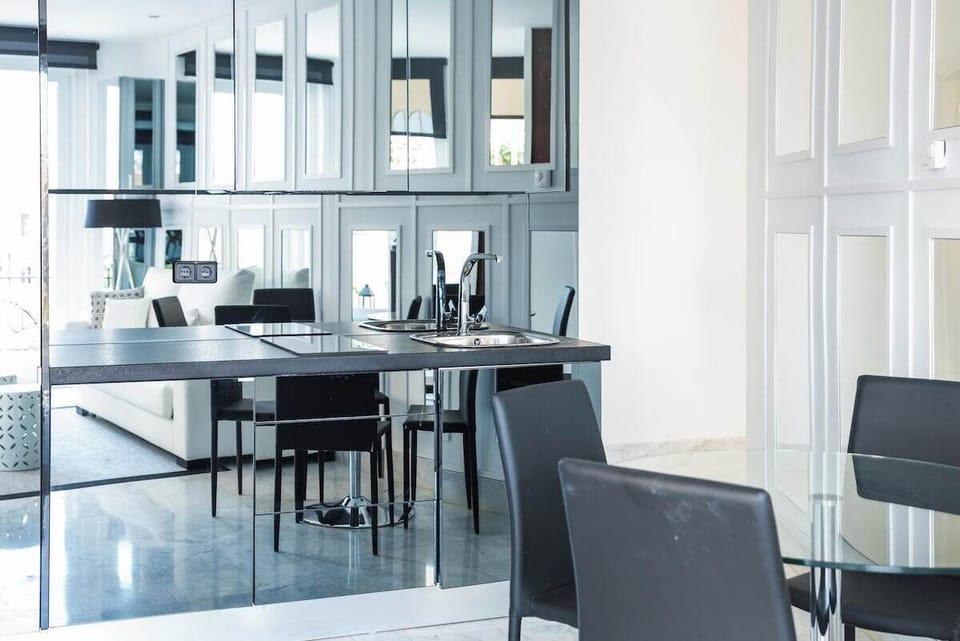 View of the fully equipped kitchen area and dining table.