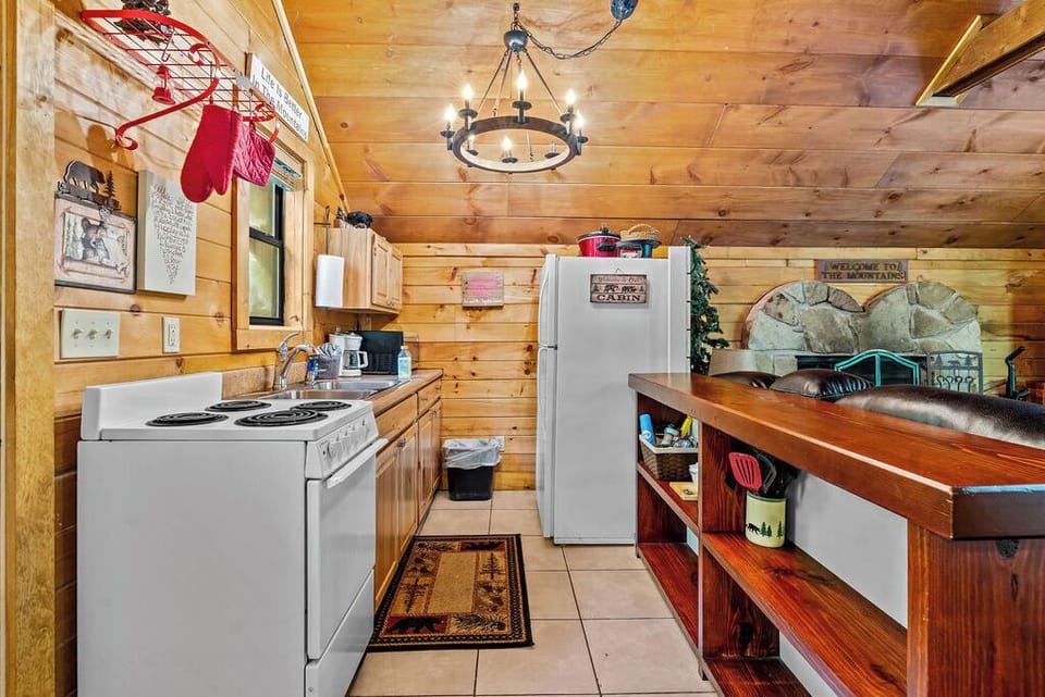 Discover the charm of our compact kitchen in the cozy cabin. With everything at arm's reach, this little space packs a punch for all your culinary needs.