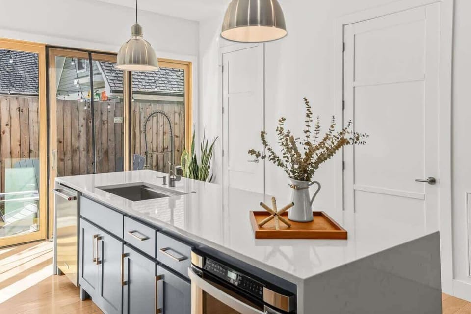 Open kitchen offers ample prep space and a deep farmhouse sink. 