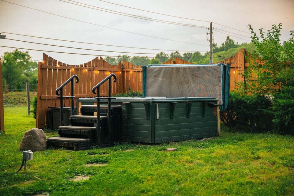 Your own private soak spot- unwind in the hot tub under the string lights with peaceful views all around!