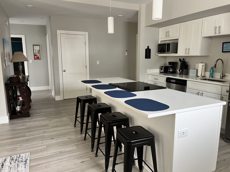 Take a seat at the island to keep the chef company.  Common space is wide open -- everyone can be together.