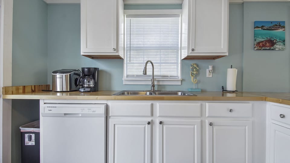 The kitchen has a dishwasher, coffee maker and a separate ice maker. 