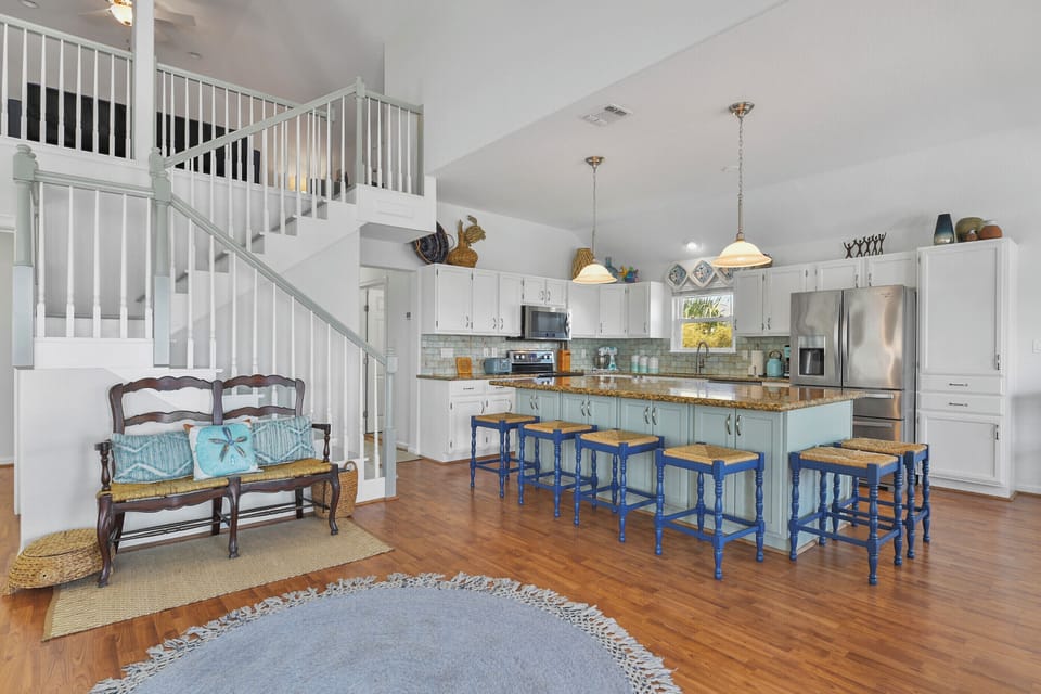 The kitchen and stairs up to the flex space.
