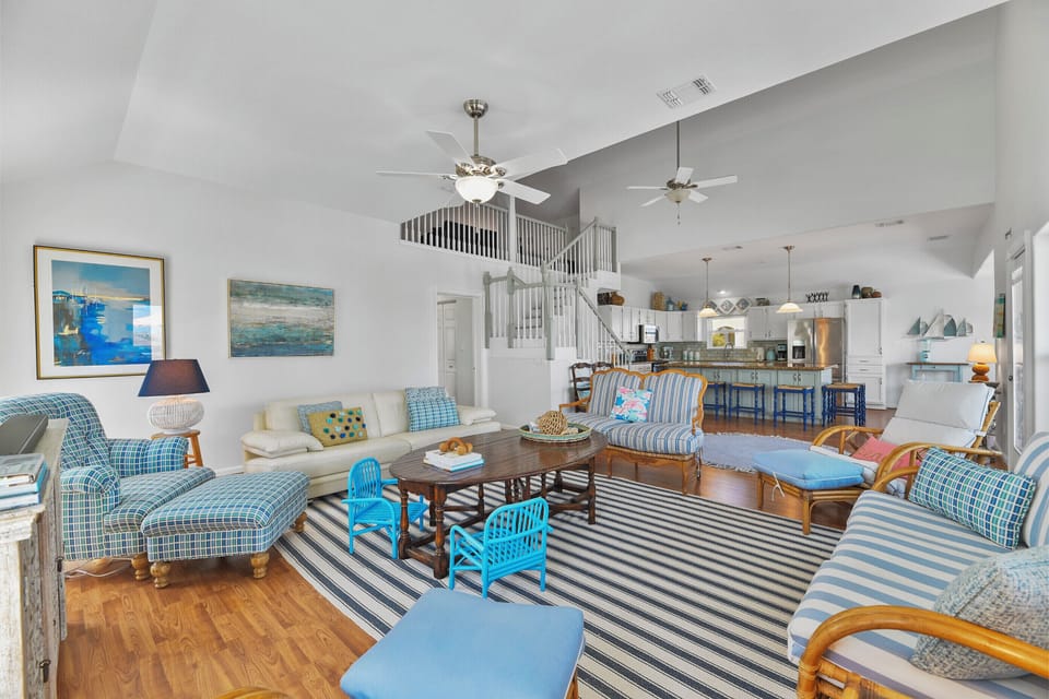 Living room with abundant seating looking towards the kitchen.