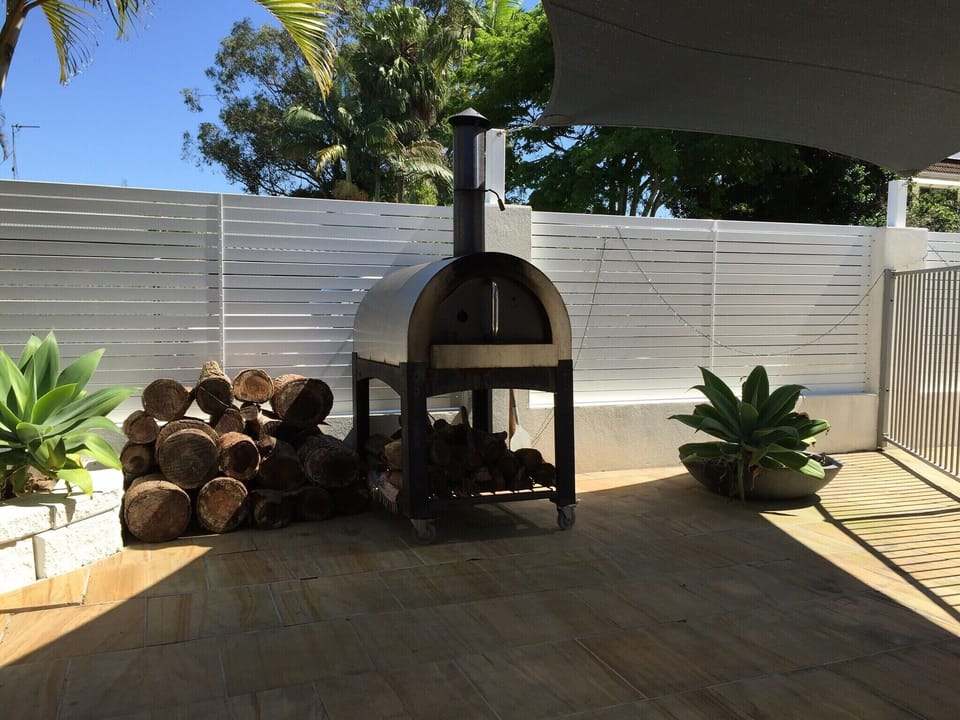 cook your own pizzas in a wood fired pizza oven
