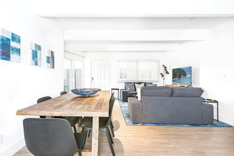 The open floor plan between living, dining, and kitchen makes for easy group hangouts after a day at the beach.
                