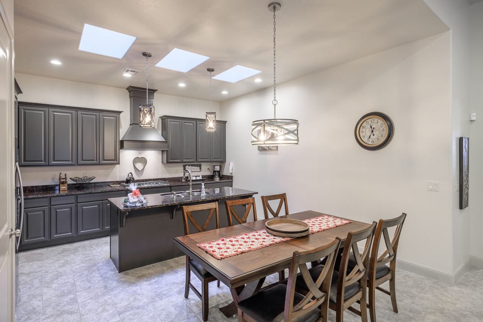 Dining Table and Kitchen - The kitchen is fully stocked with all the dishes, cookware, baking pans, and cutlery you will need for meal preparations and includes stainless steel appliances and granite counter tops.
