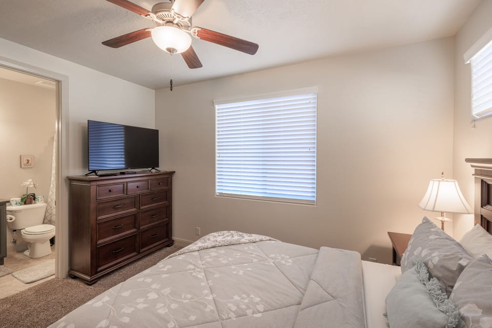 Bedroom 4 - Bedroom 4 includes a Queen bed, private TV, bathroom, and closet.