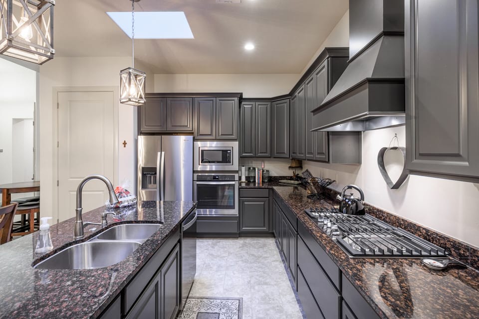 Kitchen Side View - Side view of kitchen showing off the beautiful counter tops and stainless-steel appliances.