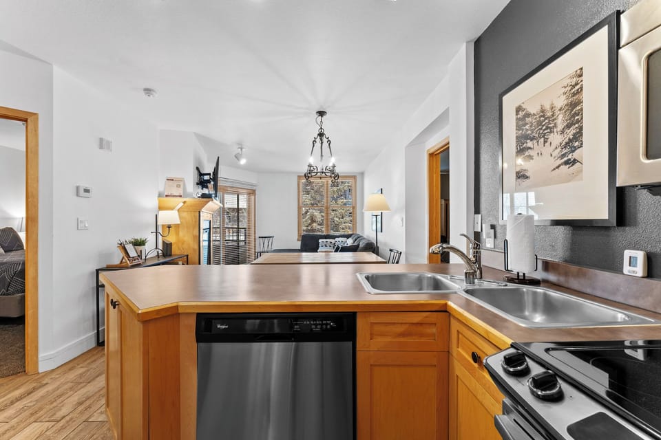 Your modern kitchen flows seamlessly into the bright living space, creating the perfect setup for memorable meals together.