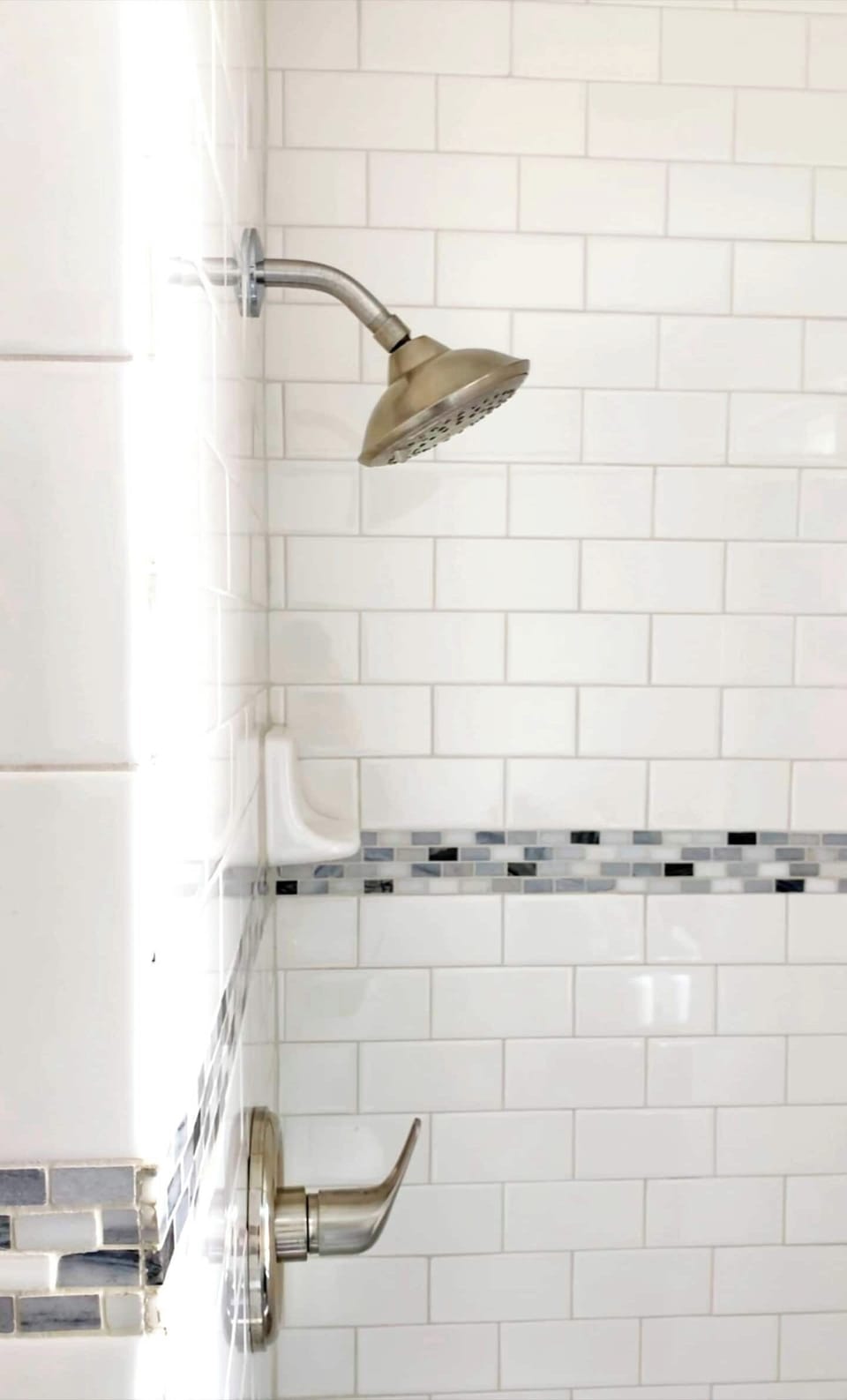 A Full Restroom with a hair dryer, shampoo, body wash, towels, toilet paper and conditioner