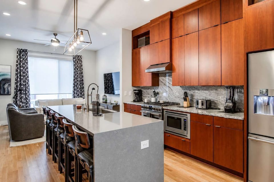 Fully stocked kitchen with a stylish island, stainless steel appliances, and plenty of space for cooking and gathering.