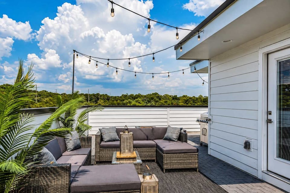 Outdoor rooftop retreat with sectional, BBQ grill, gas firepit, and cornhole