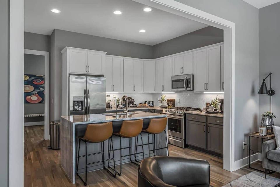 Modern kitchen with island seating for three, perfectly connected to the living space for gatherings.