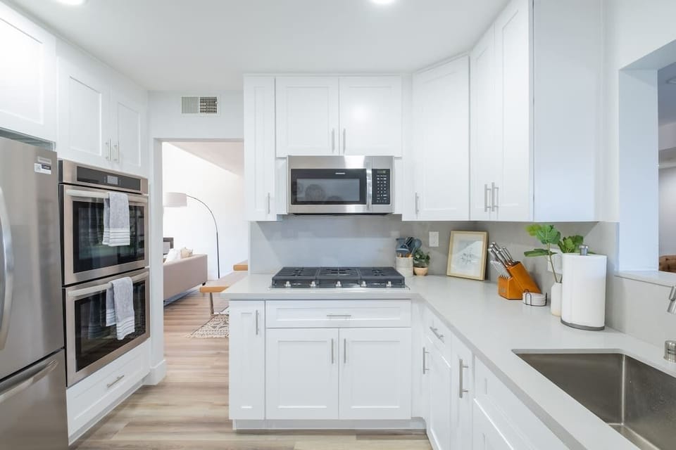The chef-friendly kitchen features double ovens, a French door fridge and quality cookware