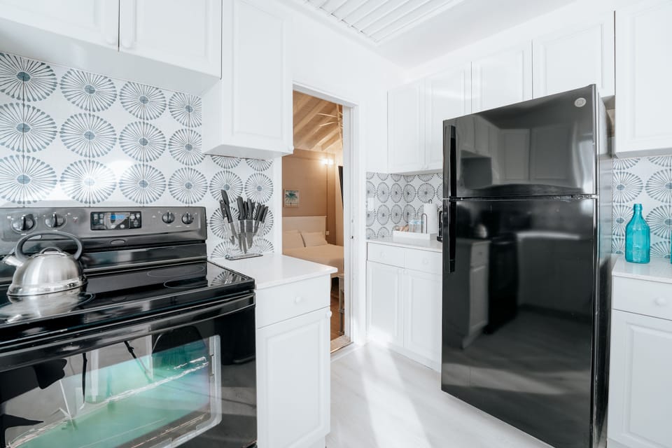 Deluxe Room, Multiple Beds, Non Smoking | Private kitchen | Fridge, microwave, oven, stovetop