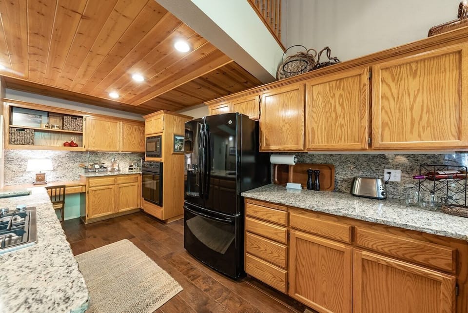 The kitchen is open to the dining area. It is a great space to visit while preparing meals.