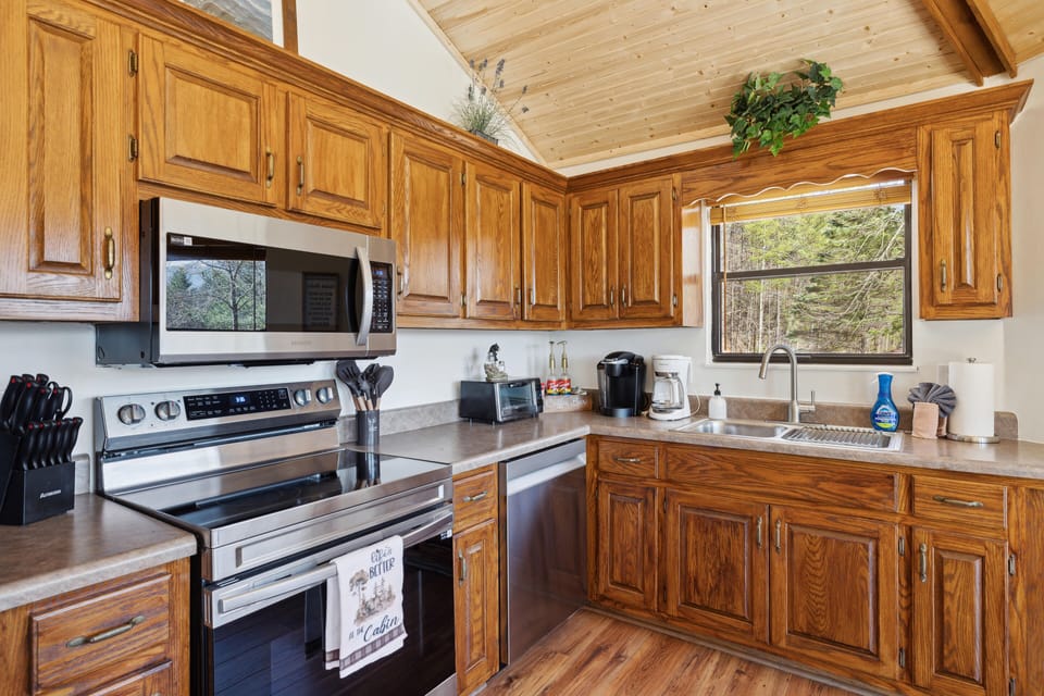 Full kitchen stocked with utensils, cookware, and coffee bar.