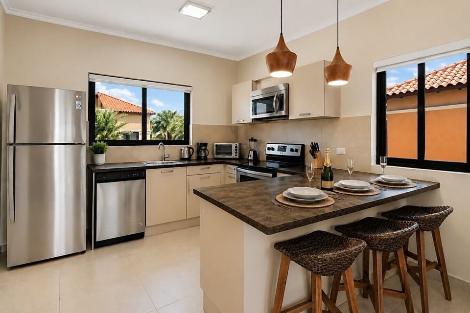 Fully equipped kitchen featuring modern appliances, cookware, essentials, and ample space for meal preparation.