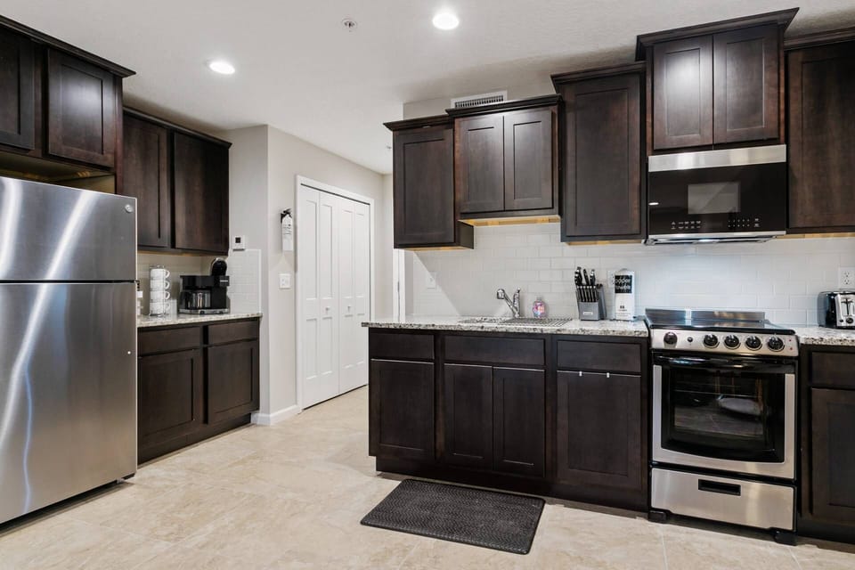 Kitchen with Stainless Steel Apartment Size Refrgerator/Freezer and Oven/Stove