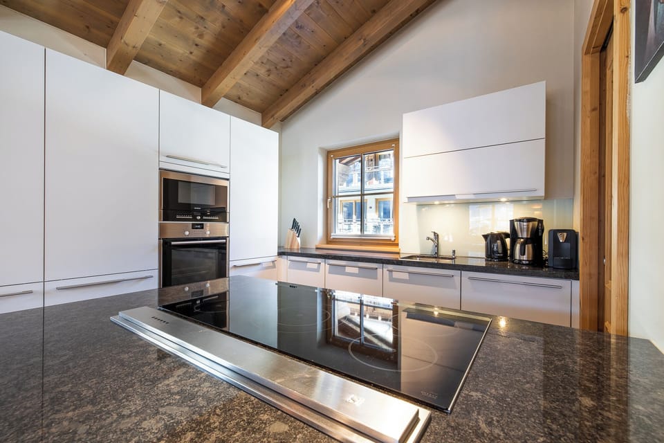 Eight-Bedroom Chalet | Private kitchen | Espresso maker, coffee/tea maker, highchair, dining table