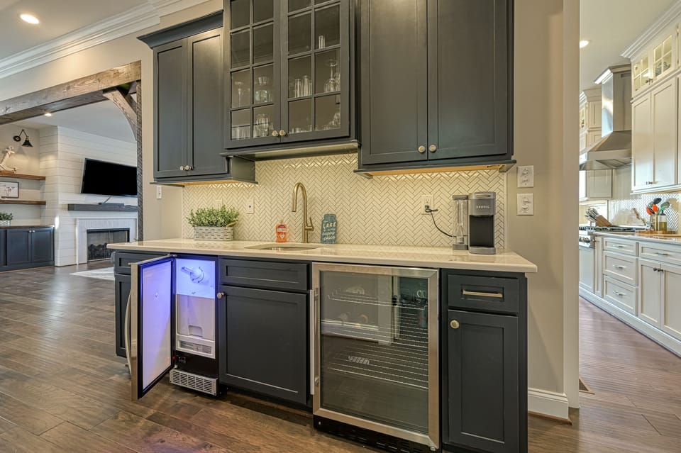 Well appointed bar area with prep sink, icemaker and beverage fridge.