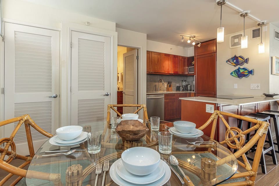 Your stylish open-concept space flows from dining to kitchen with warm wood cabinets and modern appliances