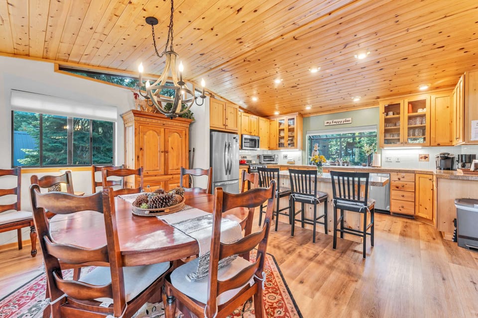 Kitchen and Dining Room: Fully-equipped kitchen, kitchen bar with/3 bar stools, range of cookware, access to deck, 8-person dining table 