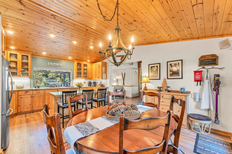 Dining Room: 8-person dining table, situated between kitchen and living room, access to upper deck

