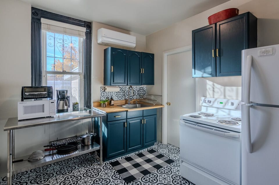 Full kitchen with large fridge, oven, toaster oven and microwave