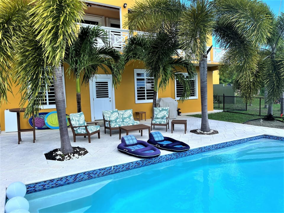 Outdoor seating in the shade of the palms