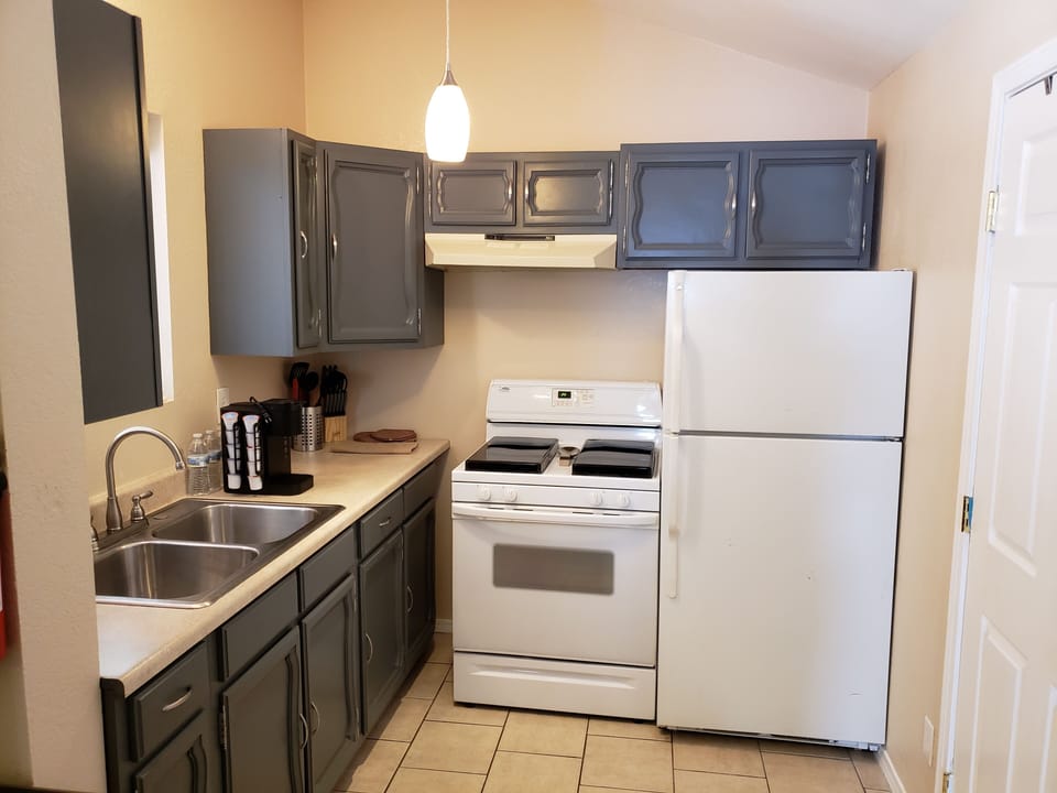 Pots, pans, dishes, utensils, refrigerator, gas range, Keurig, microwave.