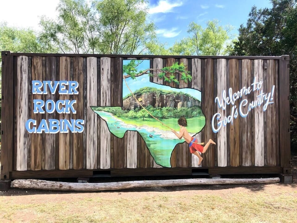 Take a group / family photo in front of our River Rock mural.