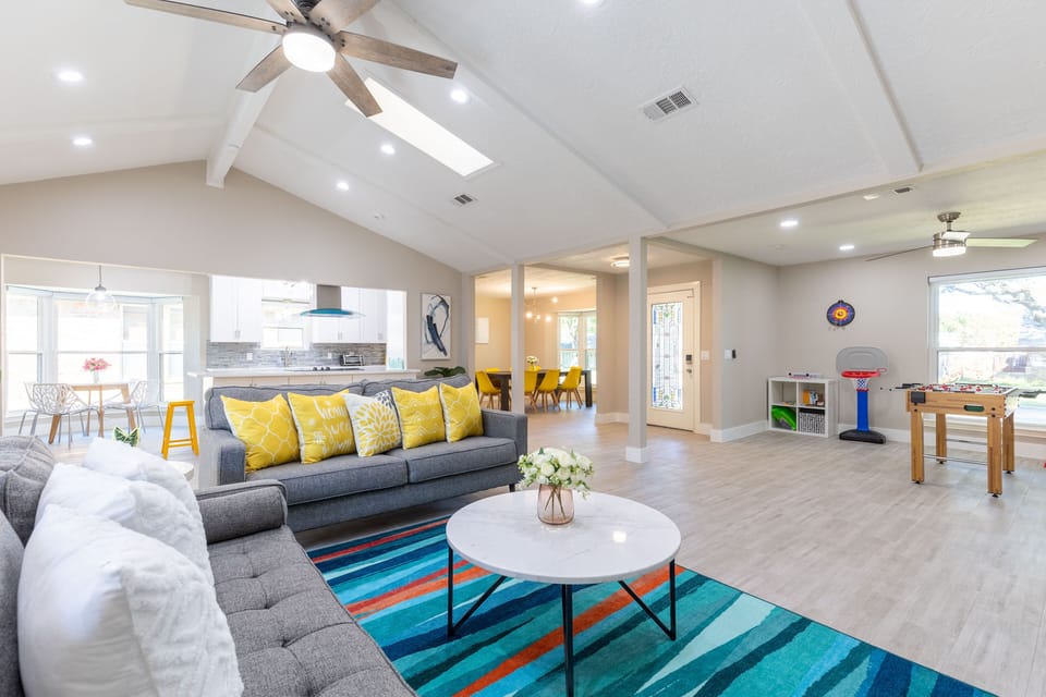 The living room opens to the kitchen, breakfast nook, dining room, and game area