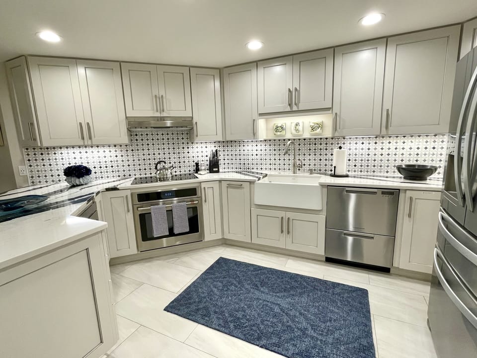 This gourmet kitchen w/ an induction stove & farmhouse sink make cooking a joy!
