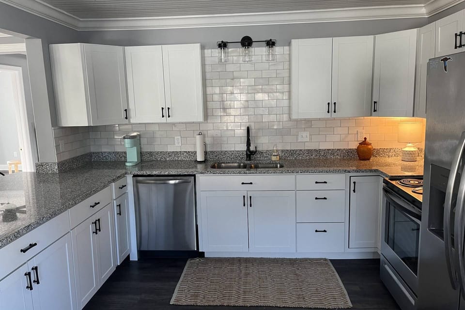 Fully stocked kitchen has ample dishes, glasses, silverware, bowls, pots and pans for quick food on the run or full meals.