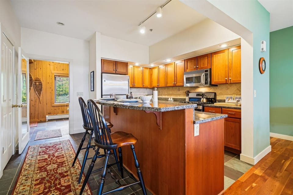 Start your day with coffee at the breakfast bar or unwind with a glass of wine while dinner simmers. This inviting nook keeps everyone connected from morning to night.