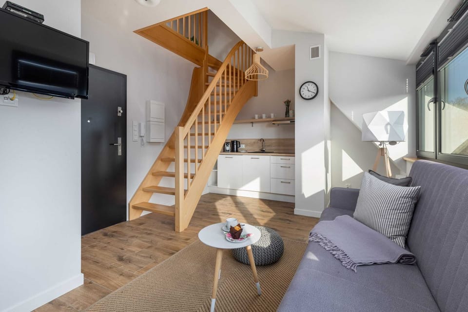 A wide view of the staircase and the open-plan living room.
