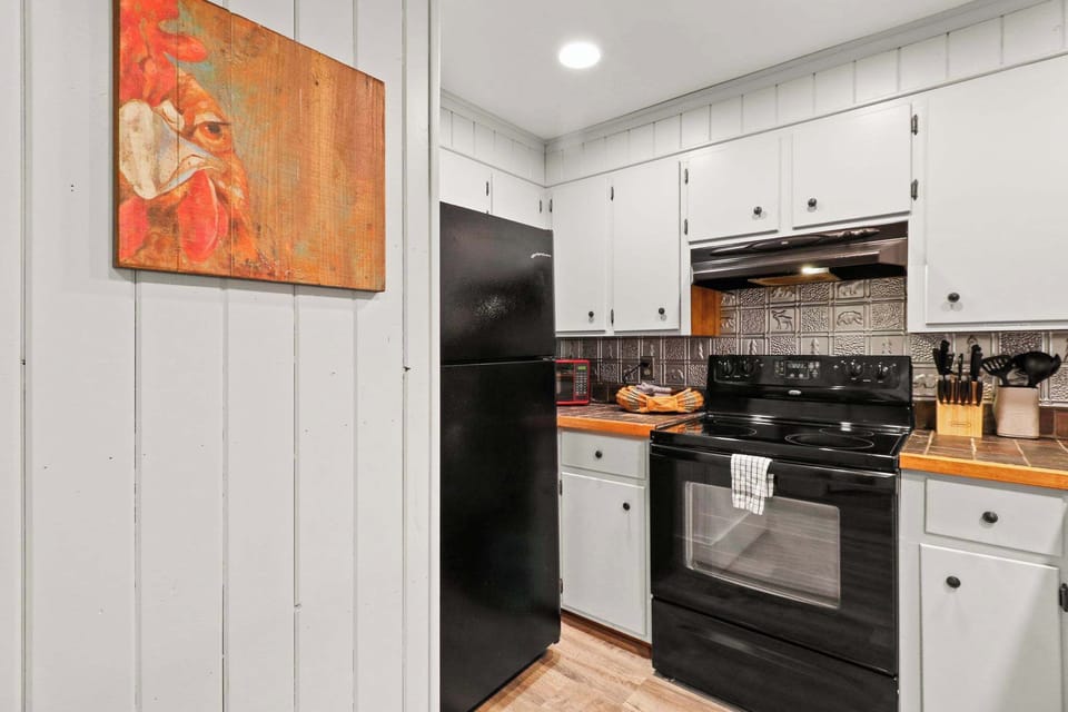 Culinary delights meet cozy nights: A fully equipped kitchen and stylish bar seating area seamlessly open into an inviting living room, setting the stage for countless memorable evenings.