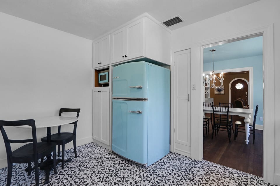 The kitchen is equipped with a refrigerator, stove, oven, microwave, and farmhouse sink
