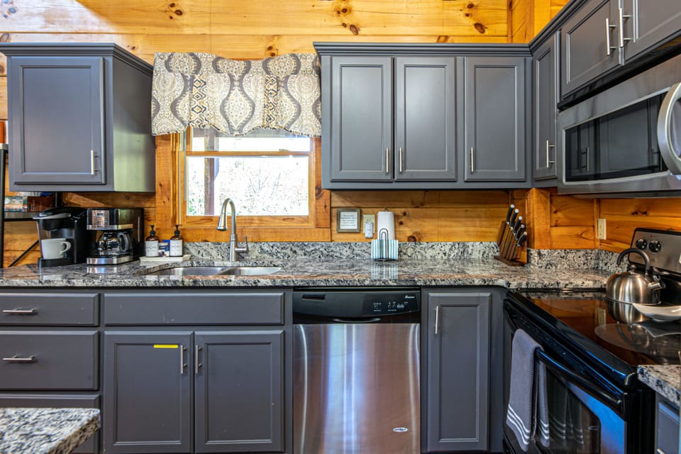 Kitchen equipped with stainless steel appliances, two coffee makes (Keurig and traditional drip coffee)