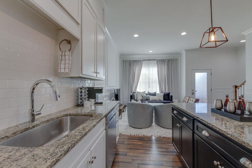 The kitchen from a different angle shows the full island workspace and the clean modern aesthetic.