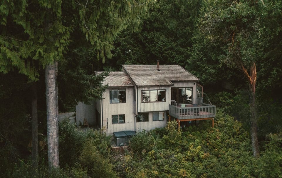 Tucked among the cedars, the cabin sits above the bay for optimal views.
