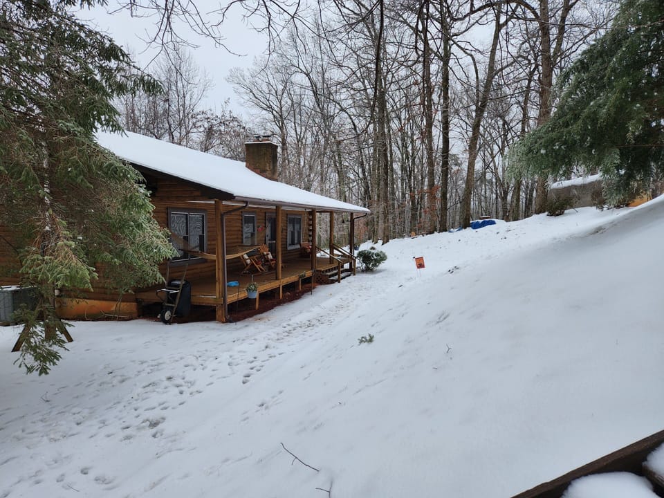 Blanketed by the first snow of 2025, the two wood stoves keep the cabin cozy!