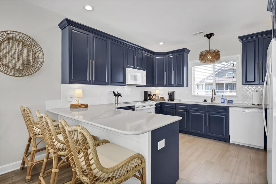 Large kitchen with new appliances, plenty of storage, and bar seating