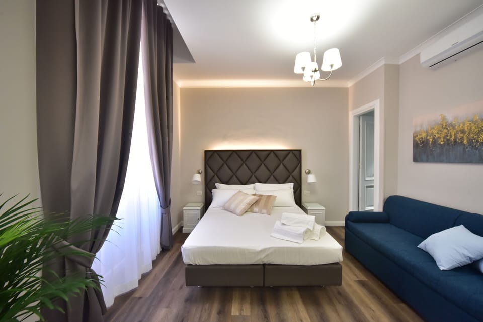 Superior Triple Room | Minibar, in-room safe, desk, blackout drapes